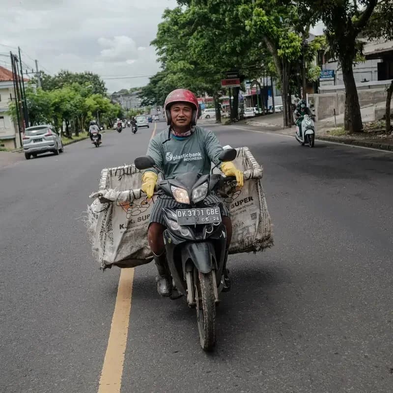 Juhari uses a motorbike to take his recycling to a branch