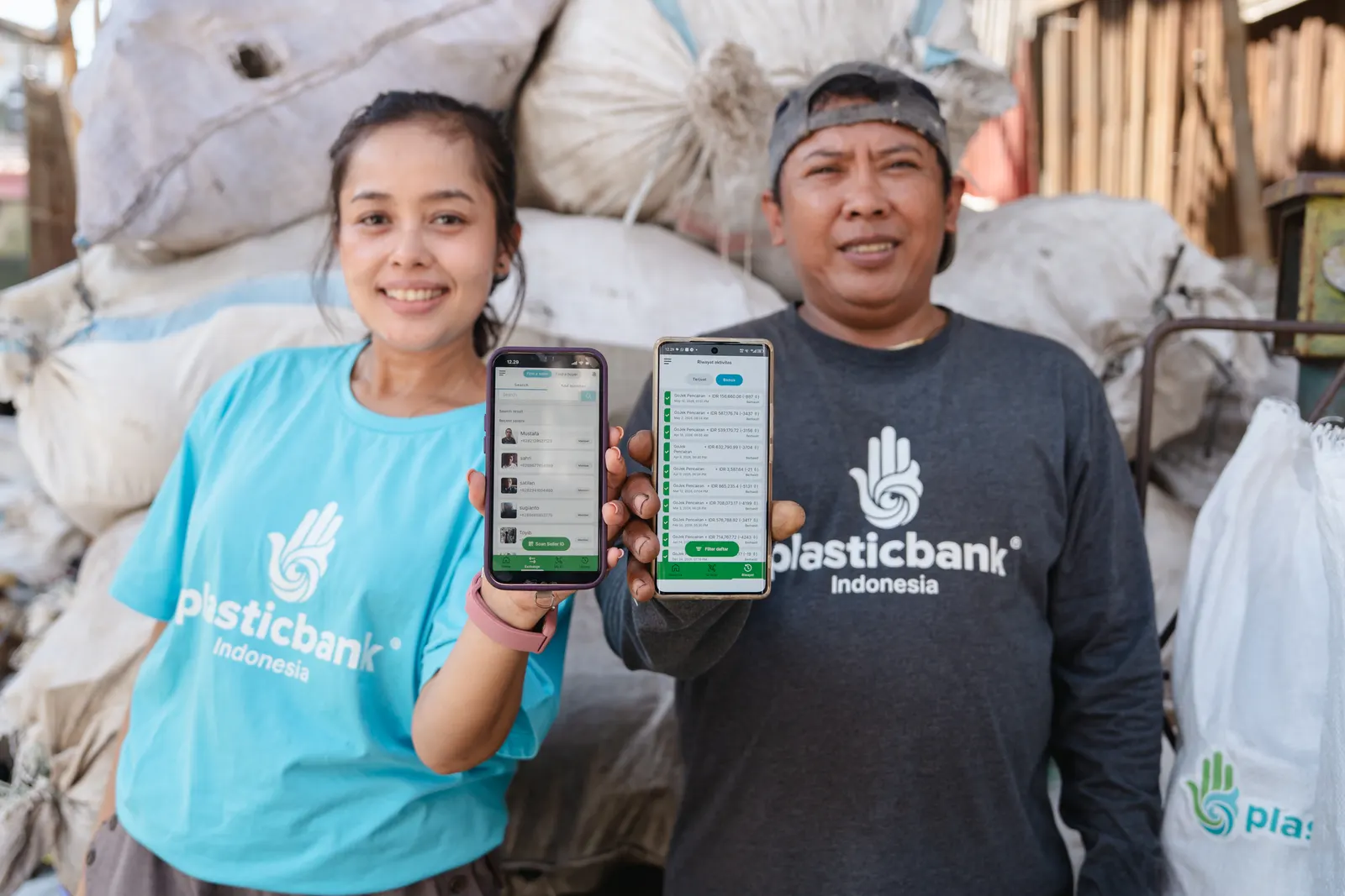 Two Plastic Bank collectors in Denpasar, Bali, showing their gathered plastic recorded in the app