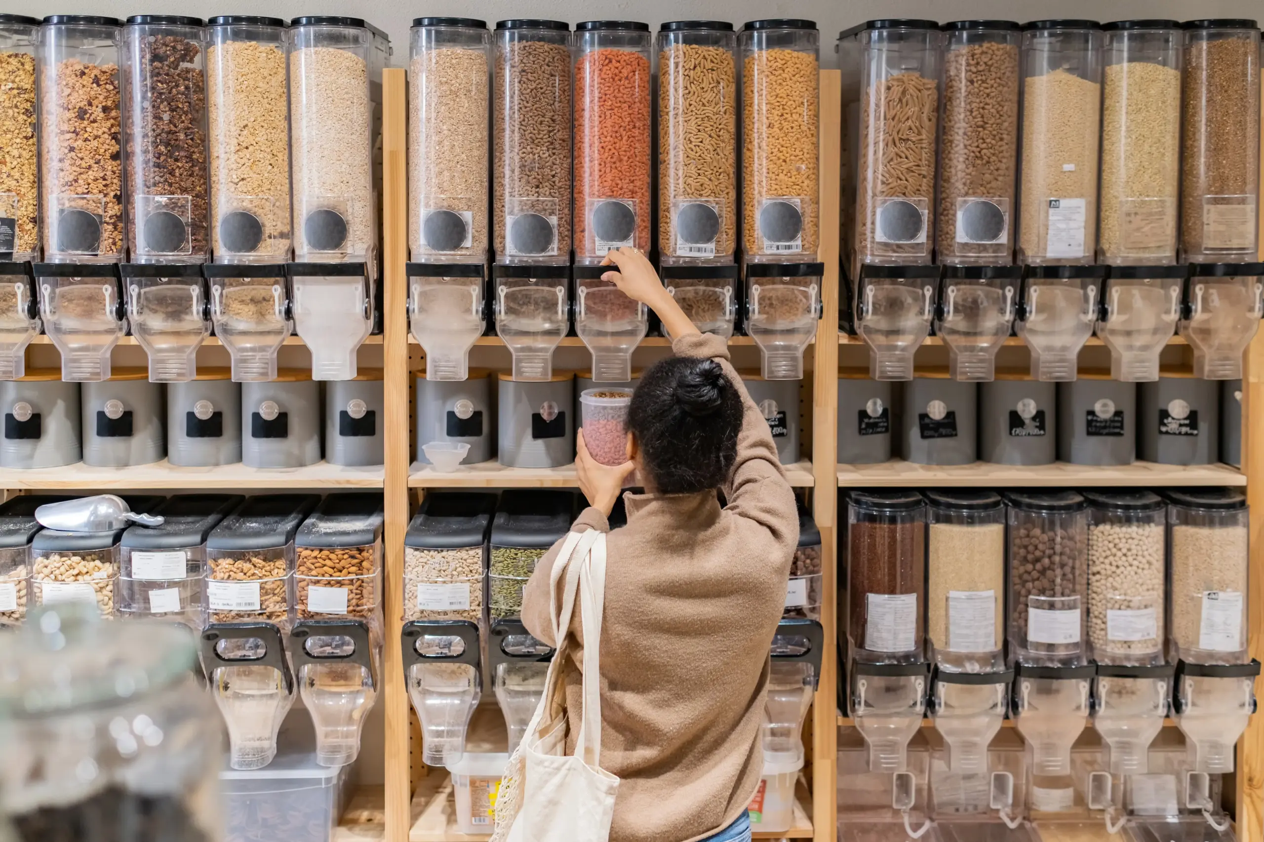 a woman purchasing from a refill station