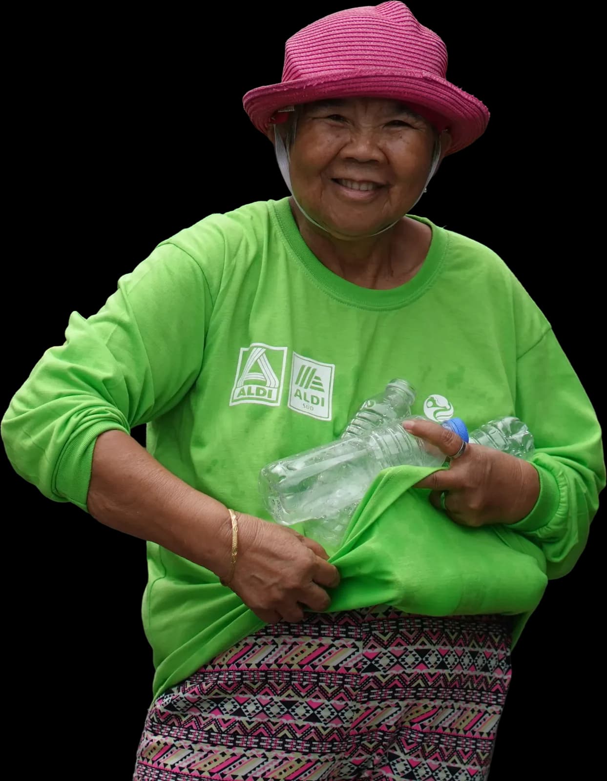 Elizabeth, a Plastic Bank collection member in Baseco, Manila, carrying gathered bottles in the front of her shirt