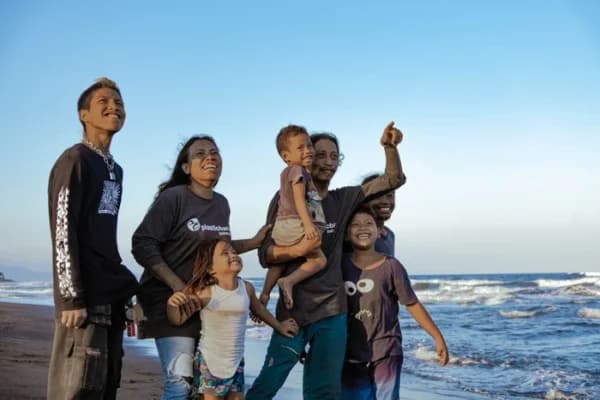 Plastic Bank member Haris Sofyan with his family on a beach in Indonesia