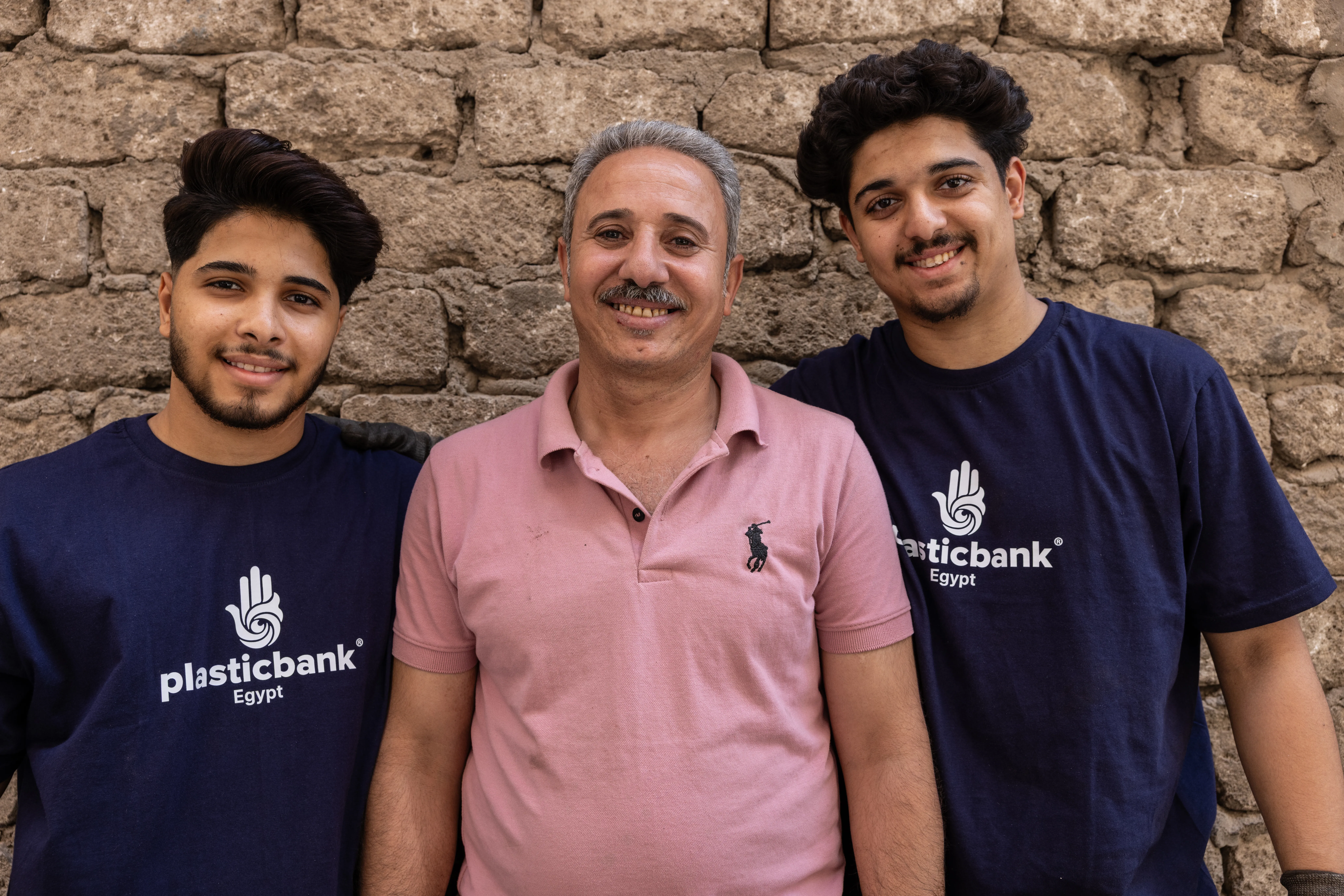 Men standing Infront of plastic collection branch in Cairo