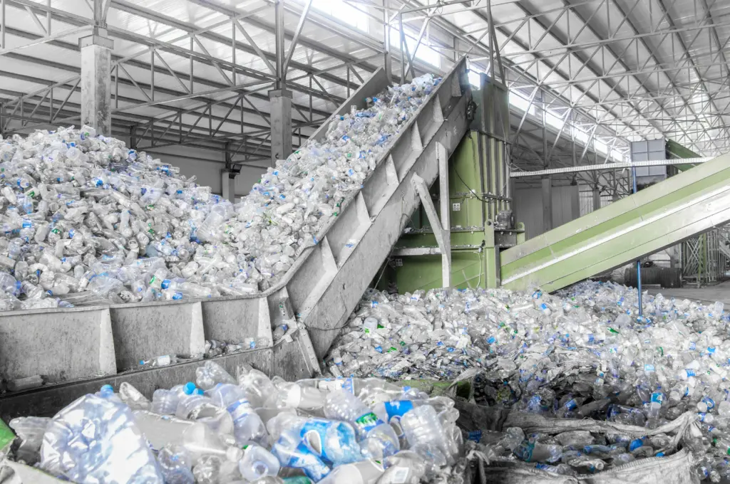 closeup escalator with a pile of plastic bottles at the factory to create recycled plastic 